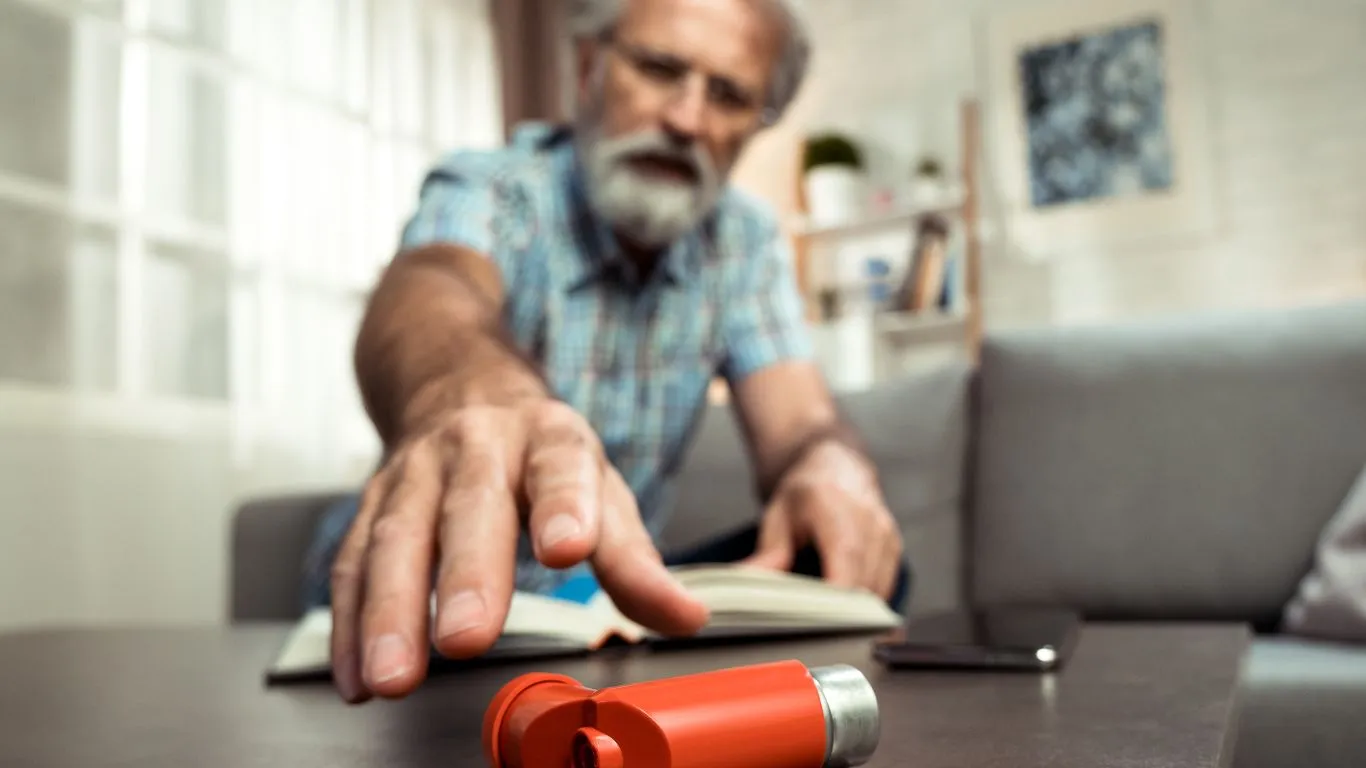 toddler inhaling asthma medication through an inhaler