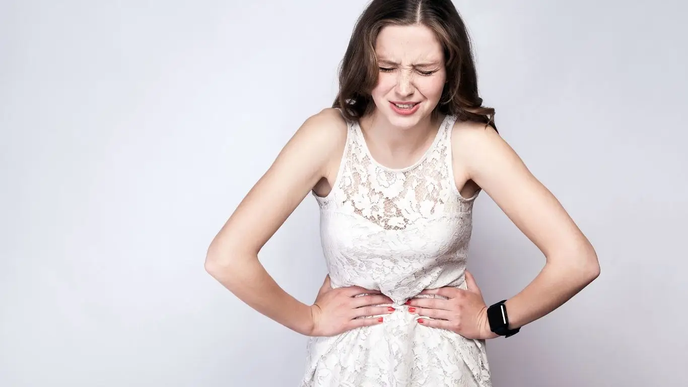 Laptop open to a health education website with notes and a cup of tea nearby