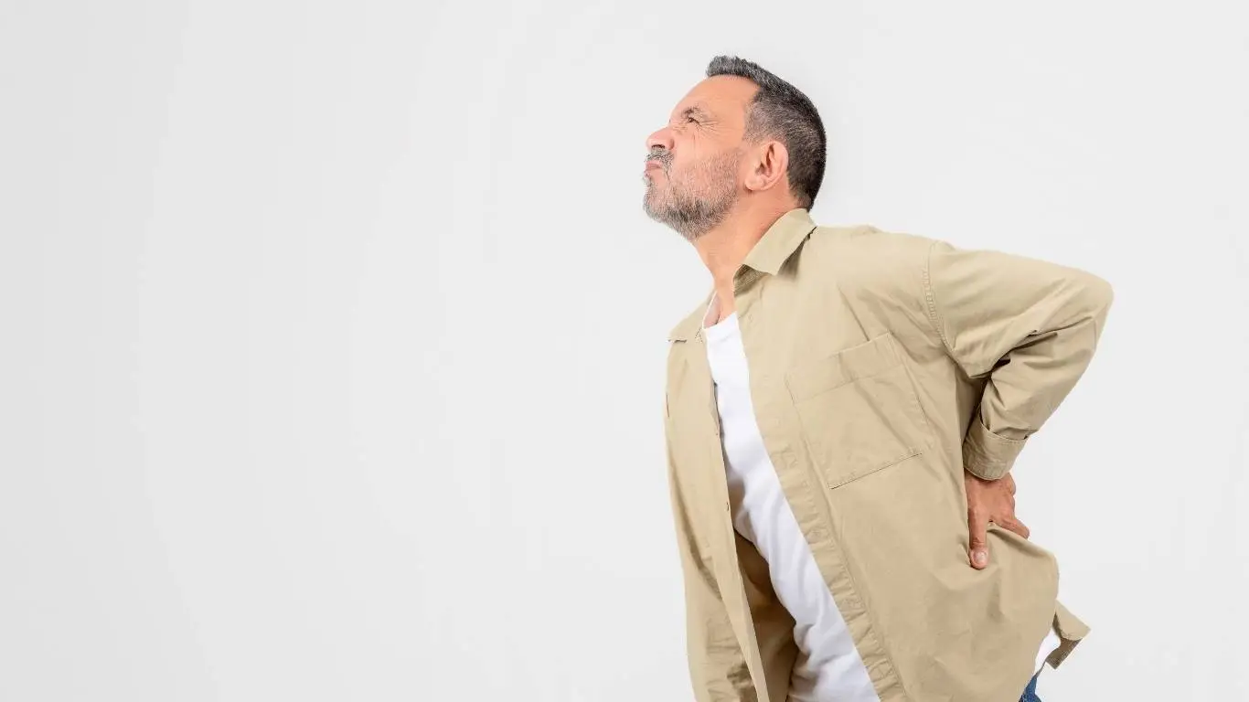 Person switching sitting position to ease tailbone pain