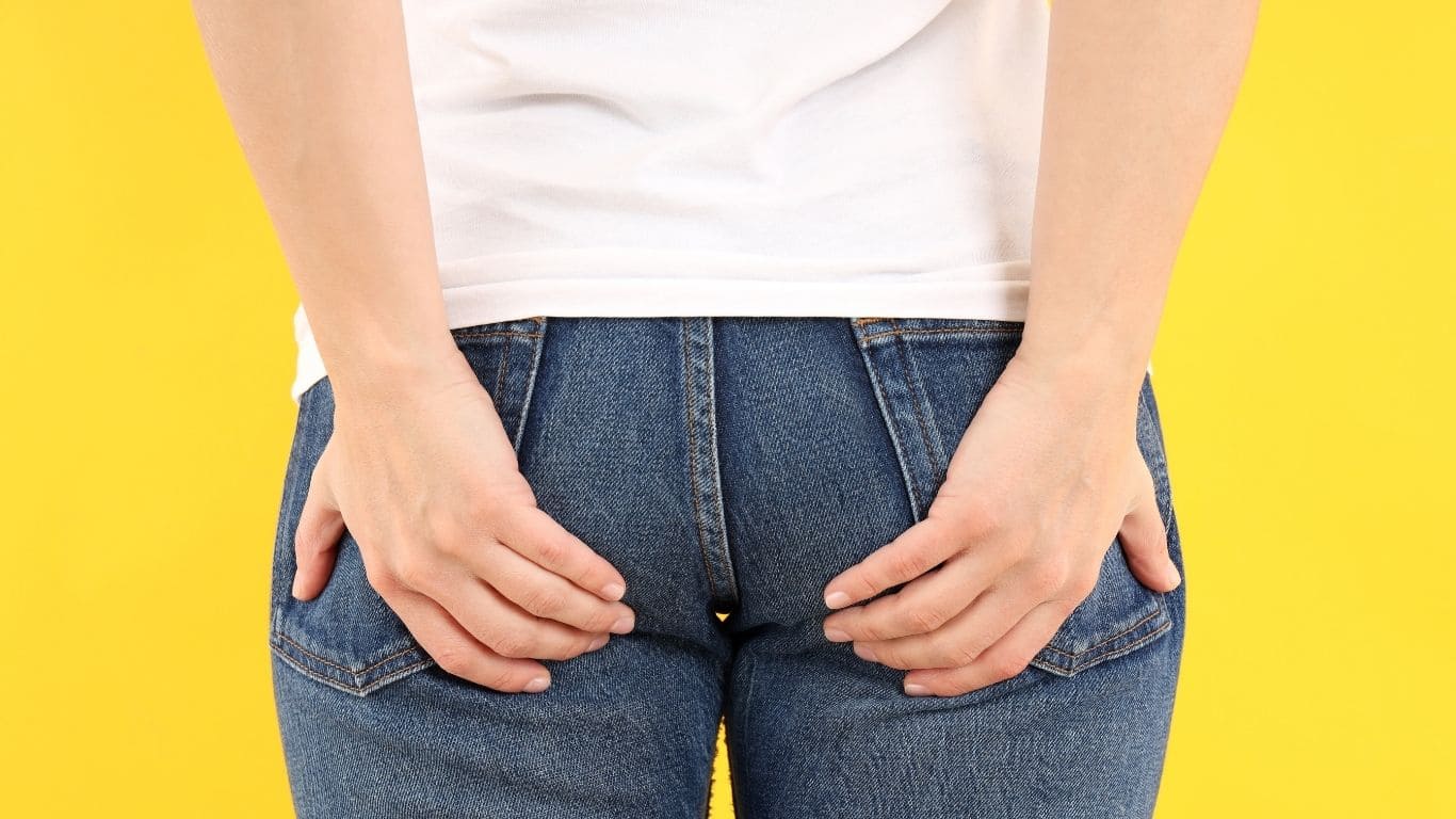 Pregnant woman experiencing discomfort from hemorrhoids