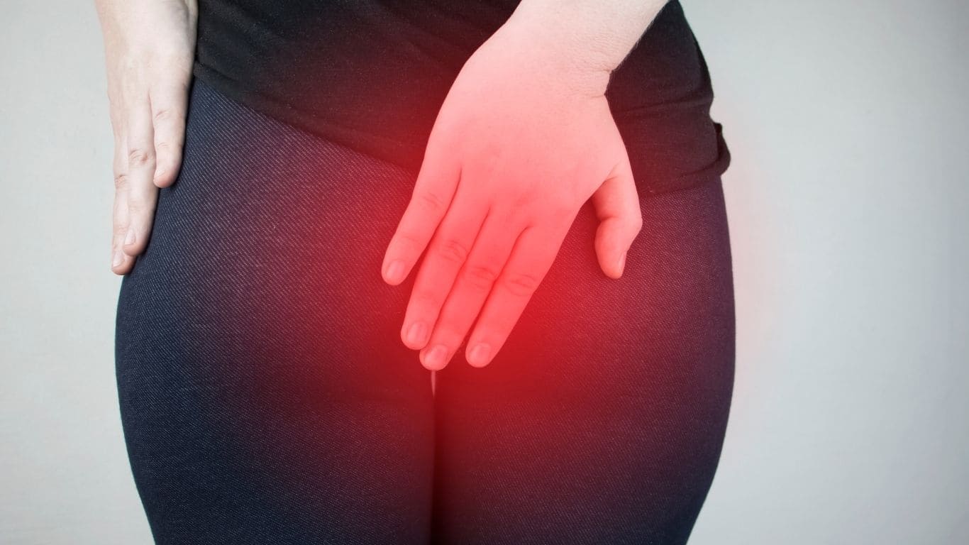 Postpartum woman consulting doctor for hemorrhoid symptoms